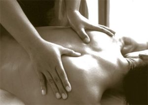 a masseuse rubbing a patient's back